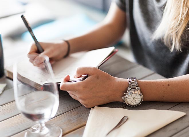 writing coaching woman writing in notebook